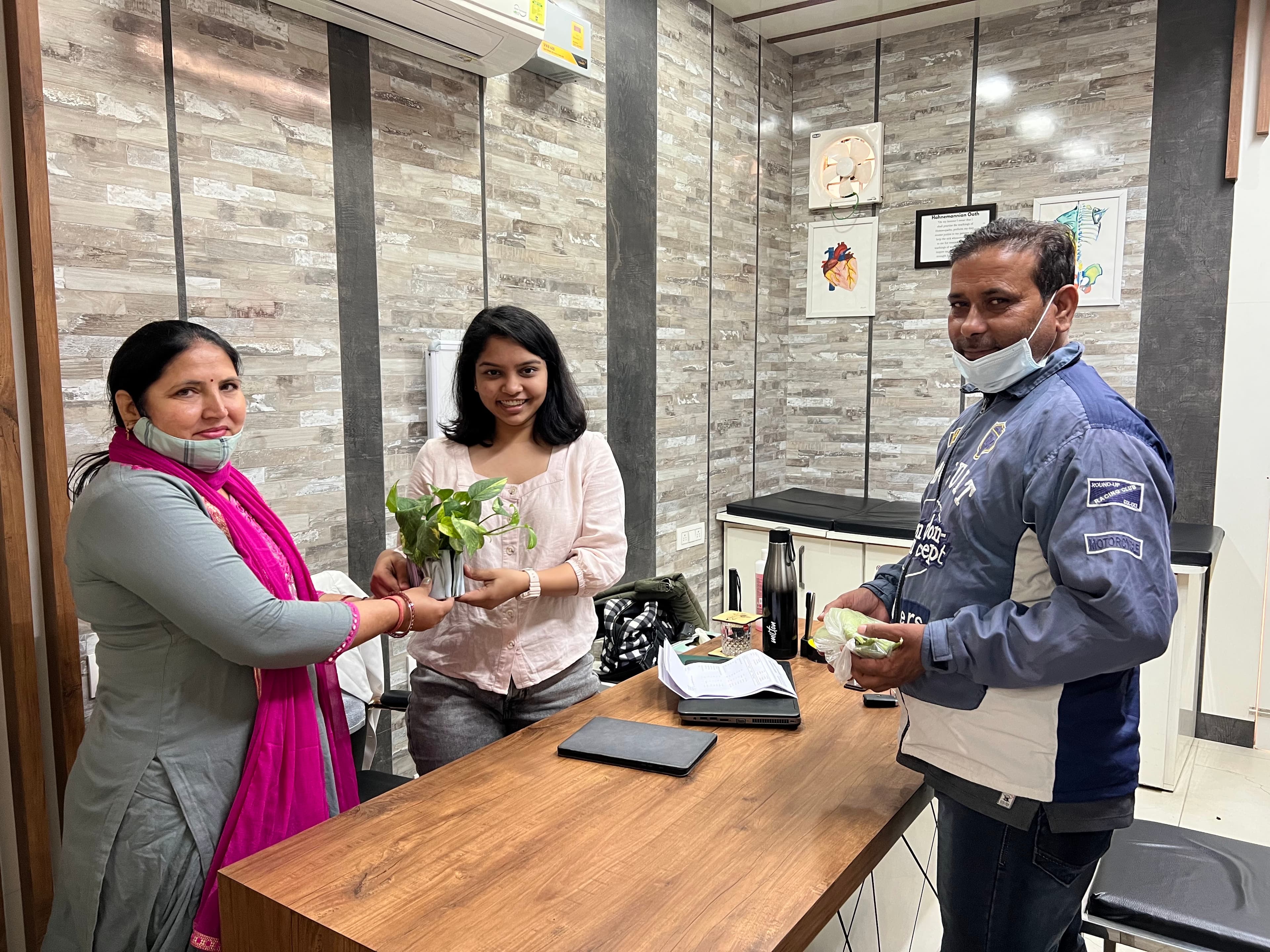 Patient and her husband gifting a plant to Dr. Shweta as a token of gratitude